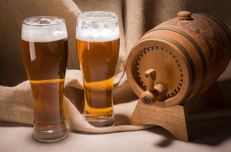 Wooden barrel with beer glasses on canvas background.の写真素材