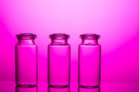 Empty little bottles on nice pink background.の写真素材