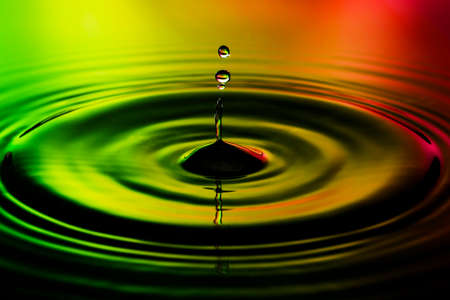 Abstract photo of water drops on nice red yellow green background. Nice texture and design photo.の写真素材