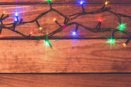 Valentines or christmas romantic lights on wood background with copy space.の写真素材