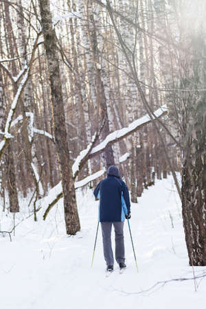 Man riding on ski on the snow in the winter park.