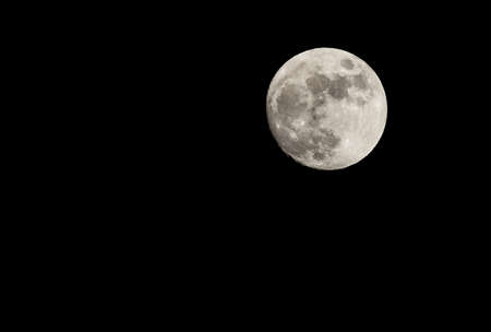 Full moon in the night sky in winter.の写真素材