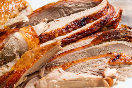 Peking Duck - Chinese roast duck with cucumber pieces on white plate close up.の写真素材