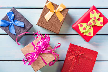 Colorful gift boxes on nice blue wooden background.の写真素材