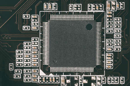 Computer chip close-up and contacts on the motherboard. Toned image. Focus on the chip.