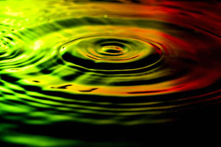 Water ripples on nice yellow green red background.の写真素材