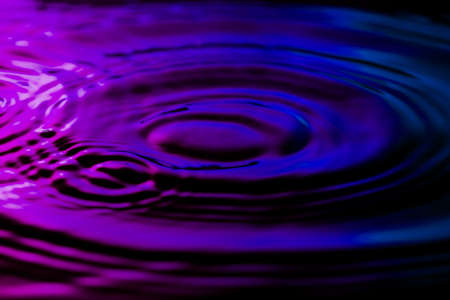 Water ripples on nice purple blue background.の写真素材