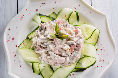 Vegetable salad with meat, herbs and spices on white plate.の写真素材