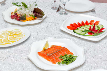 Table served with various dishes in restaurant.の写真素材