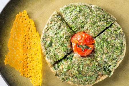 Herb omelette with tomato. Close up image and top view.の写真素材