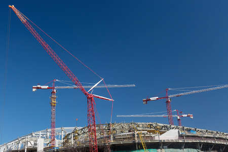 Football stadium construction with cranes and blue sky in Moscow.の写真素材