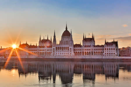 Parliament and riverside in Budapest Hungary during sunrise with sunbeams.の写真素材