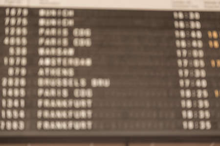Toned disfocused detail view of a typical airport information board.の写真素材