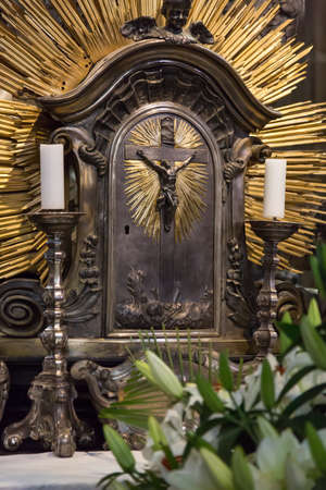Crucifix with candles in the catholic church.の写真素材
