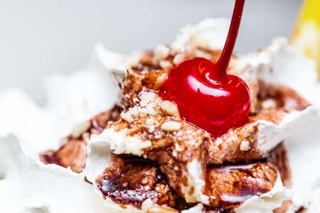 Milk cocktail with chocolate, nuts and cherry on top. Close up image.の写真素材