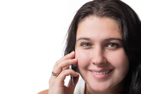 Smiley young woman speaking on mobile phone isolated on white background