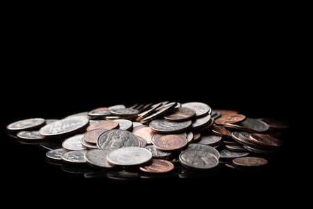 Close up of american US dollar coins on black background. Finance concept.の写真素材