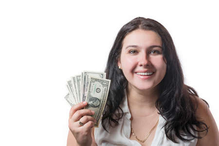 Happy smiling young brunette woman holding american dollar money isolated on white. Positive...