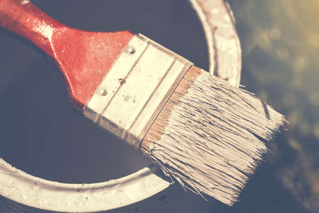 Brush on can with paint. Close up toned image with selective focus.の写真素材