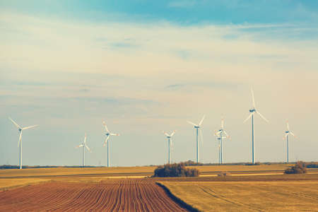 Wind turbines in the field with blue sky with clouds. Toned.の写真素材