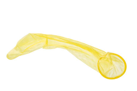 Used yellow condom isolated on white background.の写真素材