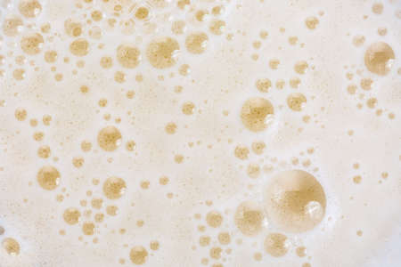 Close up of beer bubbles and foam as a background.の写真素材