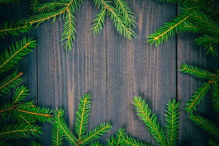 Christmas fir tree on a dark wooden board. Christmas or new year frame for your project with copy...