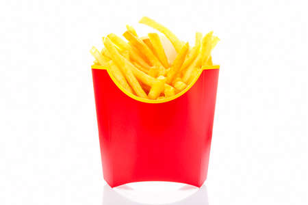 French fries potatoes in red fry box isolated on white background with reflection.
