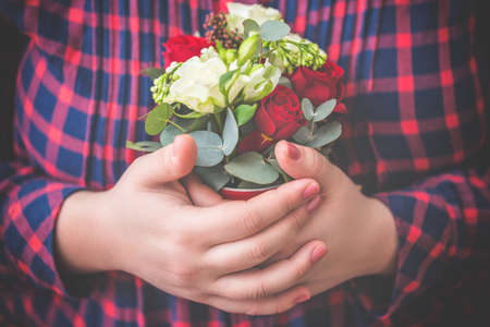 Romantic concept. Close up of flowers in female hands. Colorful and fresh flower bouquet. Toned imageの写真素材