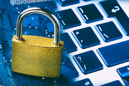 Padlock on computer motherboard and keyboard. Internet data privacy information security conceptの写真素材