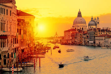 Basilica Santa Maria della Salute, Punta della Dogona and Grand Canal at sunset in Venice, Italy with boats and gondolas. Venice postcardの写真素材