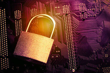 Padlock on computer motherboard. Internet data privacy information security concept. Toned image.