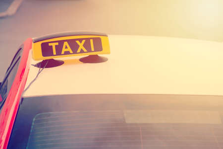 Taxi car is waiting for a passenger on the street. European tourism and travel concept. Toned.の写真素材