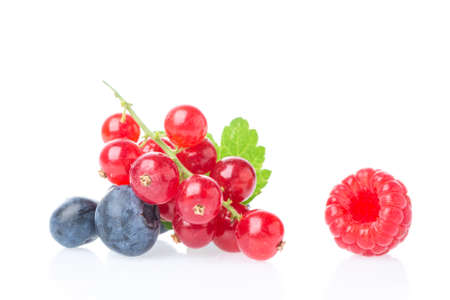 Ripe and juicy red currant berries with blueberry and raspberry isolated on white background. Healthy food mixの写真素材