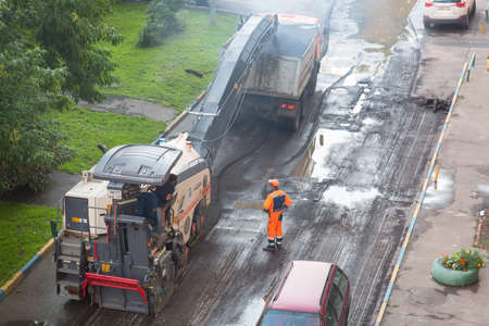 Moscow, Russia - July, 2018: Workers making asphalt at road construction in Moscow after rain.のeditorial素材