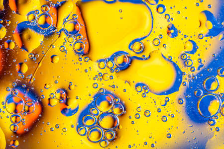Macro shot of oil bubbles with water on colorful background. Space and universe planets styled abstract image.の写真素材
