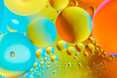 Beautiful color abstract background from mixied water and oil. Pastel colored abstraction. Yellow,...
