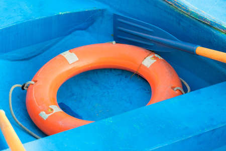 Rubber safety ring on a blue boat.