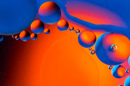 Abstract colorful background with oil drops and reflections on water surface. Cosmic abstract image.の写真素材