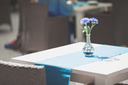 Interior of caffee or restaurant or dining room with blue flowers.の写真素材
