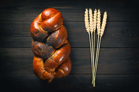 Fresh bread and wheat on dark wooden table. Top viewの写真素材
