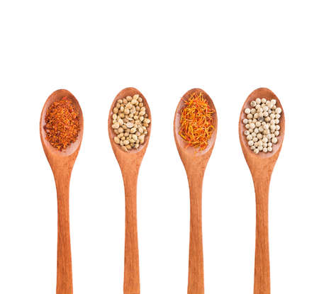 Spices mix on wooden spoons isolated on a white background. Top view.の写真素材