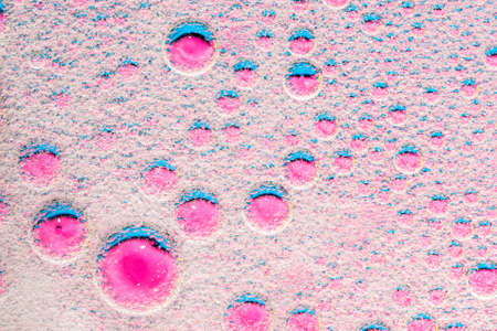 Water bubbles on pink background. Scientific image of cell membrane. Macro up of liquid substances. Abstract molecule atom sctructure. Macro shot of air or moleculeの写真素材