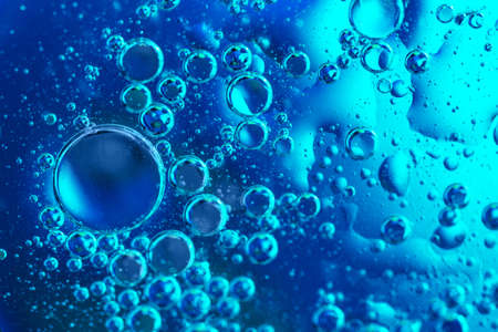 Bubbles of oxygen in water. Blue toned water structure. Selective focus