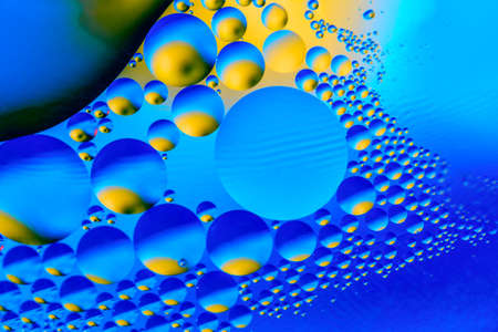 Abstract background with colorful gradient colors. Oil drops in water abstract psychedelic pattern image. Blue colored abstract pattern.の写真素材