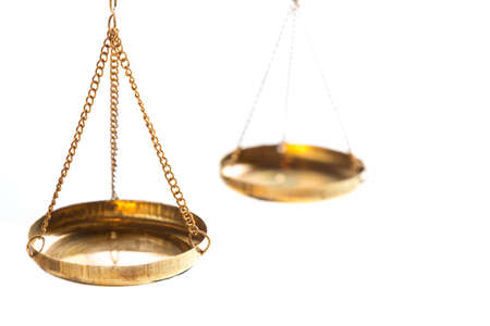 Justice law judge brass balance scales on white background. Close up with free spaceの写真素材
