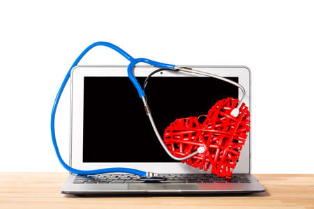 Stethoscope listening to decorative red heart on silver modern background against white isolated background. Healthcare concept.の写真素材