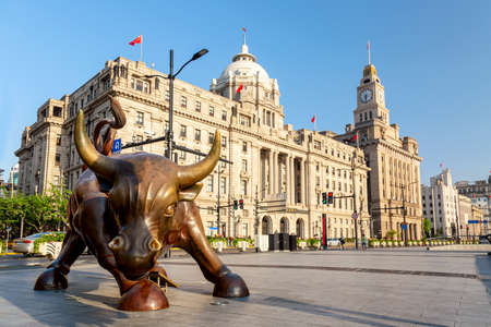Shanghai, China - May, 2019: Bronze bull on The Bund in Shanghai, Iron bull statue in front of...