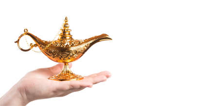 Magic lamp on female hand isolated on white background. Concept for wishing, luck and magic. Fairy tale bannerの写真素材