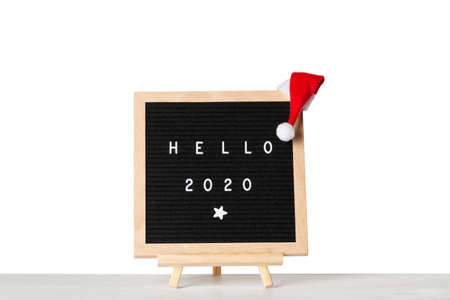 Christmas or new year frame or mockup for your project. Hello 2020 words on a letter board with...